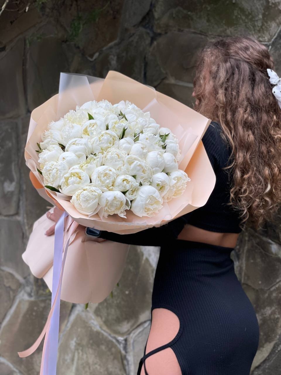Bouquet of pink Sarah Bernhardt peonies in kraft wrapping for Rotterdam delivery