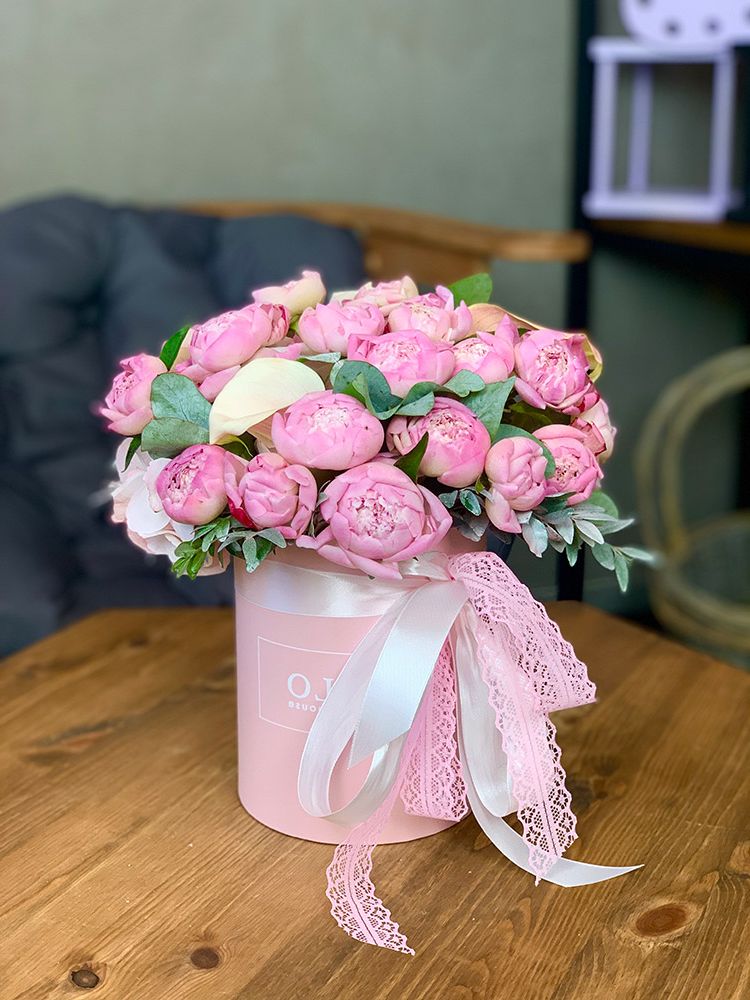 A bouquet of 11 pink Sarah Bernhardt peonies in linen wrapping
