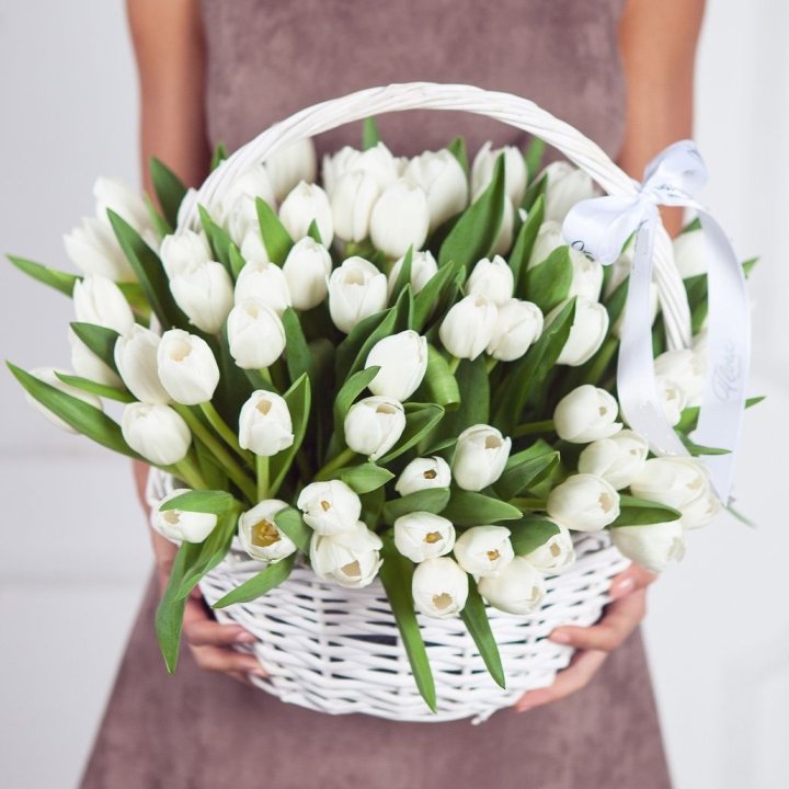 Yellow chrysanthemums and dark foliage in a bleached basket on a Dubai reception counter